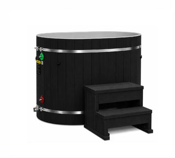 Dynamic Oval Barrel Cold Plunge in black pacific cedar with a black wooden step in front.