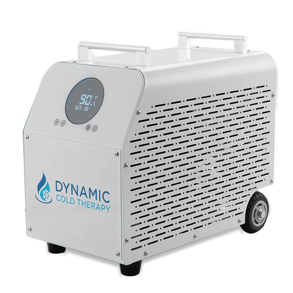 A portable cold therapy chiller machine by Dynamic Cold Therapy, featuring a white aluminum body, a digital temperature display on the front panel and caster wheels.