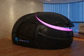 Black Dreampod V2 Float Pod with pink interior on a wooden floor, brand 'dreampod' visible.